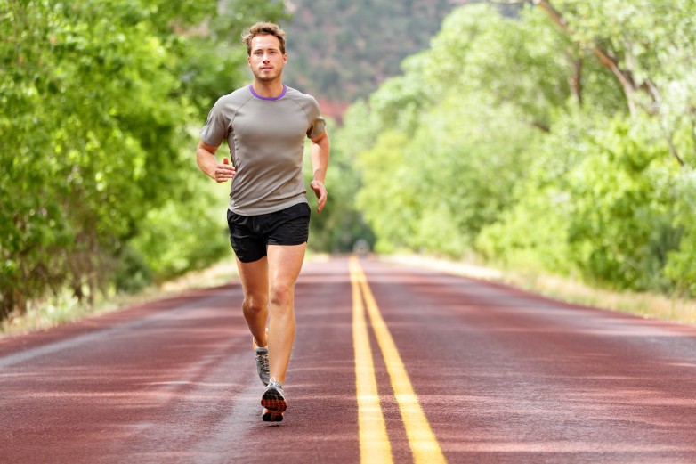 Sport and fitness runner man running on road training for marath