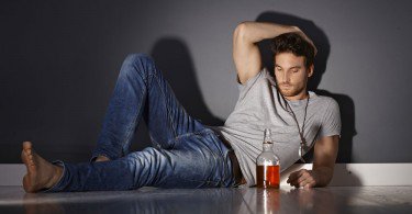 WEB-bigstock-Depressed-young-man-lying-on-f-91538753